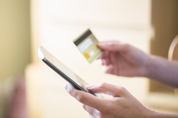 Woman shopping on the internet with smartphone and credit card