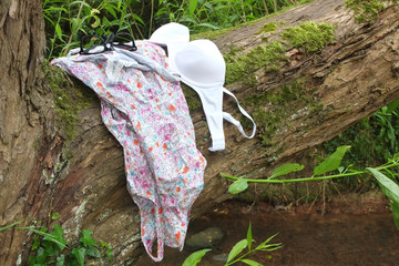 Gone swimming, Young womans clothes left on a tree.