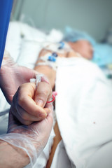 Hand in glove holding a carefully Brush a heavy patient in ICU