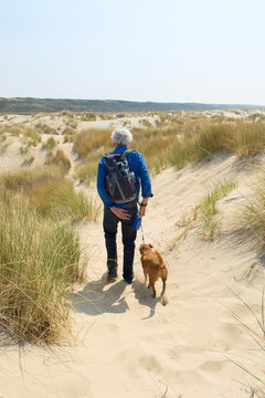 Senior Man Hiking With Dog