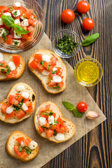 Bruschetta with roasted tomatoes, mozzarella cheese, garlic and