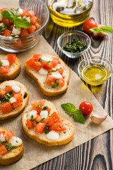 Bruschetta with roasted tomatoes, mozzarella cheese, garlic and