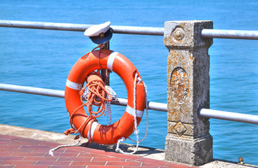 Life Belt in shining orange with a captains hat