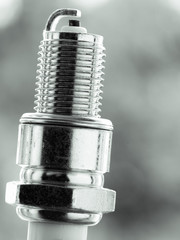 Auto service. New spark plug as spare part of car.