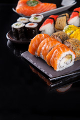 Sushi pieces on black stone
