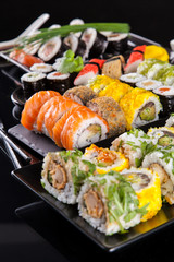 Sushi pieces on black stone