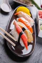 Sushi pieces on black stone