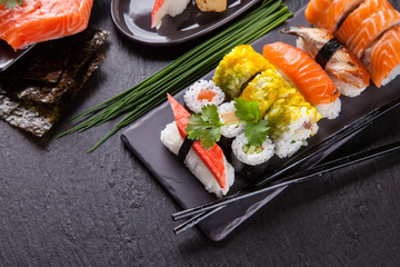 Sushi pieces on black stone