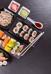 Fototapeta na wymiar Sushi pieces on black stone