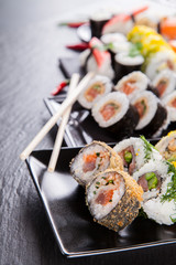 Sushi pieces on black stone