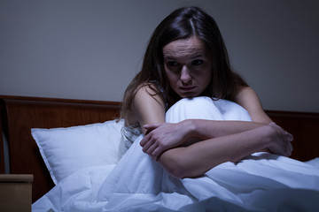Worried woman in bed