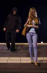 Man following woman at night