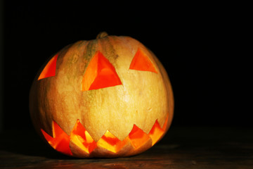 Halloween Pumpkin on wooden table, on dark background