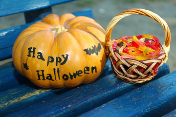 Halloween pumpkin and basket with candies