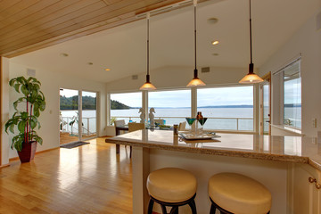 Luxury house interior. Bar counter top with stools and dining ar