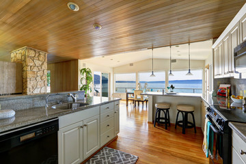 Kitchen area with paneled ceiling and hardwood floor