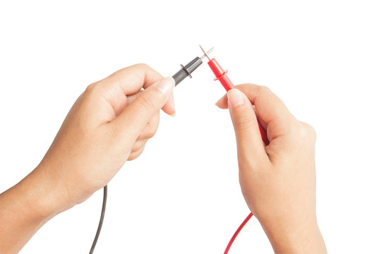 Electrician holding probes from voltmeter