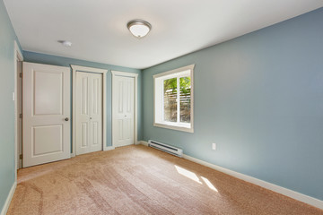 Light blue bedroom with closets
