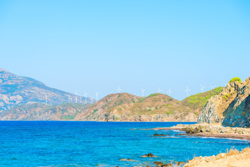 Fototapeta premium windmills generate electricity in the mountains near the sea