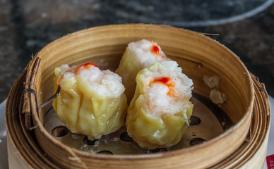 Dimsum in the steam basket . Chinese dimsum bamboo steamer