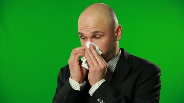 Handsome businessman sneeze, green background. FULL HD