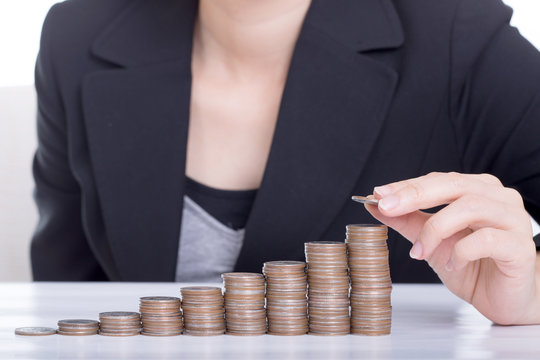 Business women put coin stack money