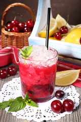 Fresh cold cherry cocktail with mint, ice and lemon