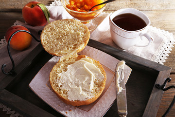 light breakfast with cup of tea and homemade jam on wooden