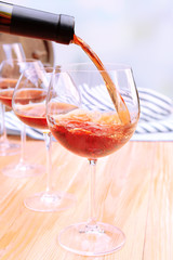 Red wine pouring into wine glass, close-up
