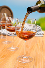 Red wine pouring into wine glass, close-up