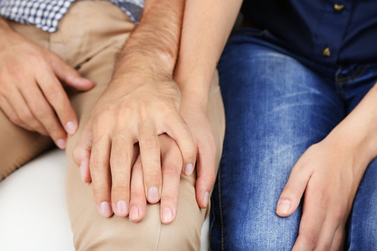Loving couple holding hands close-up