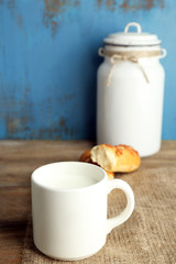 Retro still life with tasty rustic milk, on wooden table