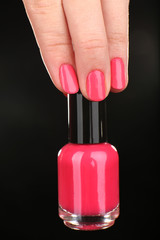Nail polish in hand, close-up