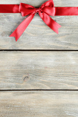 Old wooden background with beautiful bow