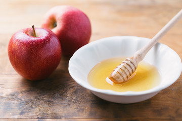 Acacia Honey and apples on wooden table