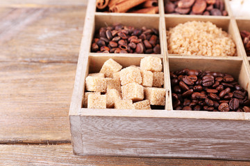 Wooden box with set of coffee and cocoa beans, sugar cubes,