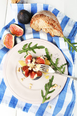 Ripe sweet fig with cottage cheese and honey, on plate