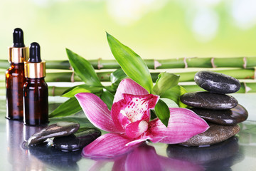 Spa stones, orchid, bamboo branches and aroma oil
