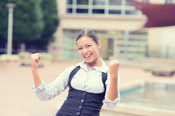 successful young business woman excited celebrates victory 