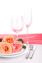 Table setting with pink rose on plate