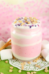 Cranberry milk dessert in glass jar,