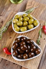 Different marinated olives on table close-up