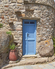 Greece, Tinos island, blue door and flower pot