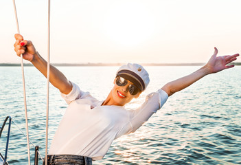 Adorable model wearing sea admirals hat and sexy top at sunset.
