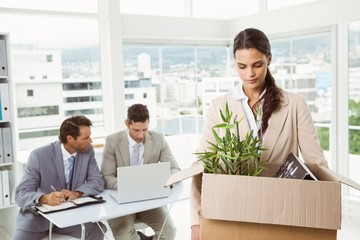 Businesswoman carrying her belongings in box
