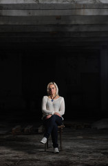 Young beautiful woman in an abandoned factory