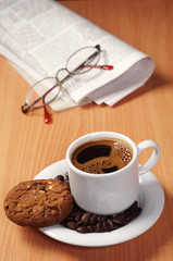 Coffee with cookie and newspaper