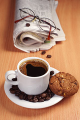 Coffee with cookie and newspaper