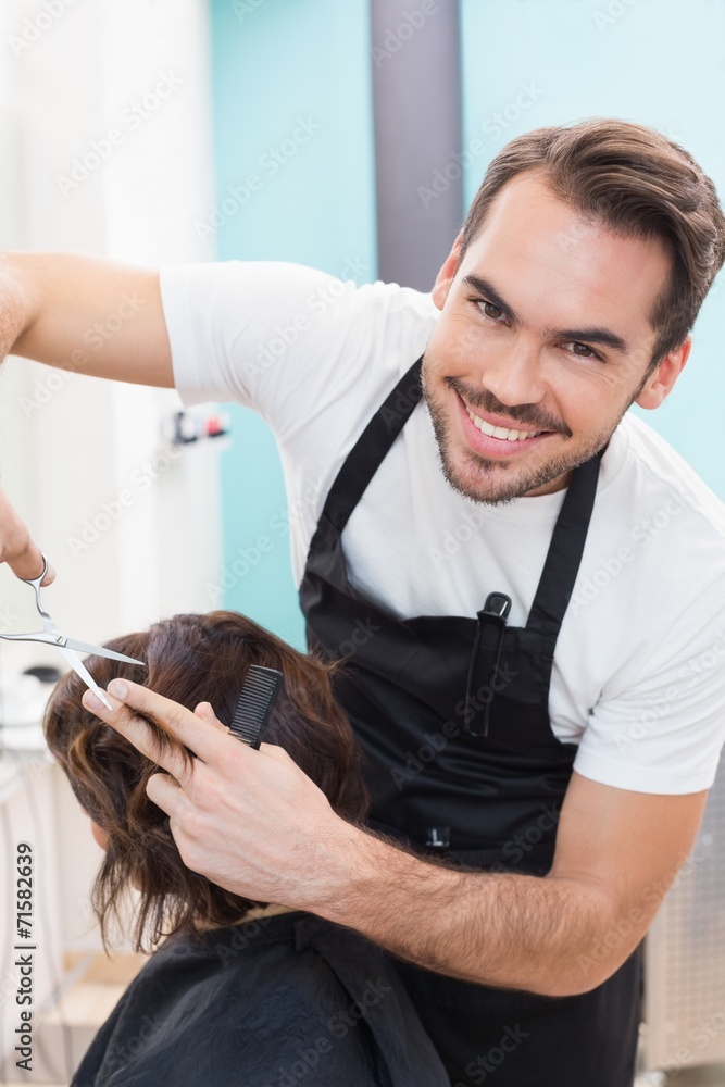 Wall mural Pretty brunette getting her hair cut