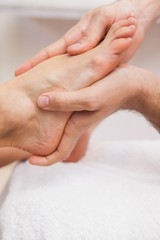 Fototapeta na wymiar Pedicurist massaging a customers feet